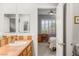 Bathroom showcasing a single sink, tiled countertops, a mirror, and an open view of a bedroom at 3535 Coventry Gardens Dr, Las Vegas, NV 89135