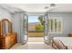 Bedroom featuring balcony access, hardwood flooring, and bright natural light at 3535 Coventry Gardens Dr, Las Vegas, NV 89135