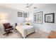 Cozy bedroom with neutral carpet, plantation shutters, and a leather chair at 3535 Coventry Gardens Dr, Las Vegas, NV 89135