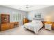 Comfortable bedroom features natural light from shuttered window and matching furniture at 3535 Coventry Gardens Dr, Las Vegas, NV 89135