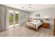Comfortable bedroom featuring a bed with neutral bedding, a balcony, and a ceiling fan at 3535 Coventry Gardens Dr, Las Vegas, NV 89135