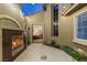 Charming courtyard with fireplace and decorative lighting; view to interior at 3535 Coventry Gardens Dr, Las Vegas, NV 89135