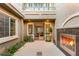 Exterior courtyard featuring a fireplace and open doorway to the house at 3535 Coventry Gardens Dr, Las Vegas, NV 89135
