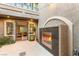Attractive outdoor space with fireplace, tiled patio, and view to the interior at 3535 Coventry Gardens Dr, Las Vegas, NV 89135