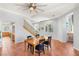 Bright dining room featuring wooden floors, stairs, ceiling fan and large window at 3535 Coventry Gardens Dr, Las Vegas, NV 89135