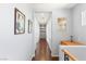Upstairs hallway featuring hardwood floors, natural light, and built-in shelving at 3535 Coventry Gardens Dr, Las Vegas, NV 89135