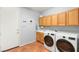 Well-equipped laundry room with modern washer and dryer, ample cabinet space, and convenient sink area at 3535 Coventry Gardens Dr, Las Vegas, NV 89135
