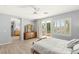 Bright main bedroom featuring balcony access, a ceiling fan, and an en suite bathroom at 3535 Coventry Gardens Dr, Las Vegas, NV 89135