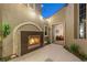 Charming outdoor courtyard with a modern fireplace, tile flooring, and open doorway at 3535 Coventry Gardens Dr, Las Vegas, NV 89135