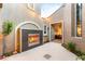 Cozy outdoor courtyard with a modern fireplace, tiled flooring, and access to the interior at 3535 Coventry Gardens Dr, Las Vegas, NV 89135