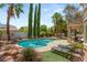 Backyard features a refreshing pool, lounge chairs, and lush landscaping at 3535 Coventry Gardens Dr, Las Vegas, NV 89135
