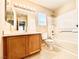 Full bathroom with tub and shower combo, wood cabinet, and tile flooring at 3542 Harbor Tides St, Las Vegas, NV 89147