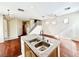 Kitchen island featuring stainless steel sink, granite countertop, and chandelier at 3542 Harbor Tides St, Las Vegas, NV 89147