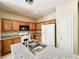 Kitchen featuring granite countertops, stainless steel appliances, and wood cabinets at 3542 Harbor Tides St, Las Vegas, NV 89147