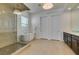 Elegant bathroom with a glass-enclosed shower, soaking tub, stylish lighting, and a double vanity at 365 Malpaso St, Las Vegas, NV 89138