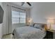 Cozy bedroom featuring a comfortable bed, ceiling fan and ample natural light from the large window at 365 Malpaso St, Las Vegas, NV 89138