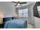 Well-lit bedroom with a comfortable bed, ceiling fan, and modern TV for relaxing and entertaining at 365 Malpaso St, Las Vegas, NV 89138
