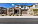 Charming two-story home with a well-manicured lawn, complemented by its beautiful stone accents and an inviting entrance at 365 Malpaso St, Las Vegas, NV 89138