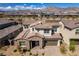 A beautiful two-story home featuring a red tile roof, lush landscaping, and a brick-paved driveway at 365 Malpaso St, Las Vegas, NV 89138