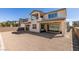 Exterior view of the home with a covered patio and spacious gravel backyard at 365 Malpaso St, Las Vegas, NV 89138