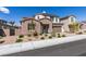 Charming two-story home with a well-manicured lawn, complemented by its beautiful stone accents and an inviting entrance at 365 Malpaso St, Las Vegas, NV 89138