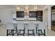 An open kitchen features a large island with seating, modern fixtures, and stainless steel appliances at 365 Malpaso St, Las Vegas, NV 89138