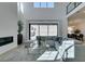 Bright and airy living room with high ceilings, comfortable seating, and large windows overlooking the backyard at 365 Malpaso St, Las Vegas, NV 89138