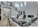 Modern living room with high ceilings, a sleek fireplace, and a staircase with glass railings at 365 Malpaso St, Las Vegas, NV 89138