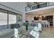 Open living space with a sleek kitchen, comfortable seating, and a clear view of the backyard through large sliding doors at 365 Malpaso St, Las Vegas, NV 89138