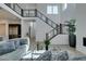 Bright living room features high ceilings, modern staircase, and comfortable seating area at 365 Malpaso St, Las Vegas, NV 89138