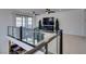 Stylish loft area with comfortable seating, a large TV, glass railings and a view to the lower floor at 365 Malpaso St, Las Vegas, NV 89138