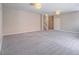 Expansive unfinished basement with gray carpet, concrete block accent wall, and ceiling lights at 420 Dakar St, Henderson, NV 89015