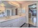 Double sink vanity featuring stone countertops and a view of the walk-in closet at 420 Dakar St, Henderson, NV 89015