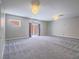 Spacious carpeted bedroom with sliding glass doors to the outside and modern light fixtures on the ceiling at 420 Dakar St, Henderson, NV 89015