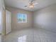 Bright bedroom with tile floors, ceiling fan, and natural light from the window at 420 Dakar St, Henderson, NV 89015