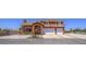 Two-story home with a terracotta facade, featuring a second-story balcony and arched entryway to the double-car garage at 420 Dakar St, Henderson, NV 89015