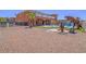 Spacious home showcasing a unique backyard with a custom pool, dinosaur decor, and ample gravel landscaping at 420 Dakar St, Henderson, NV 89015