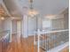 Bright upstairs foyer with hardwood floors, hardwood cabinets, staircase, and decorative lighting at 420 Dakar St, Henderson, NV 89015