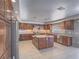 Gourmet kitchen featuring custom wood cabinetry, granite counters, and stainless steel appliances at 420 Dakar St, Henderson, NV 89015