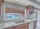 Kitchen sink with stainless steel dishwasher overlooking the sparkling outdoor pool area at 420 Dakar St, Henderson, NV 89015