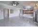 Open-concept living room with tile floors, neutral paint, and a fireplace, leading to an elevated kitchen and dining area at 420 Dakar St, Henderson, NV 89015