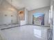 Spacious living room with tile floors, a large arched window, and a chandelier, offering a view of the terracotta house outside at 420 Dakar St, Henderson, NV 89015