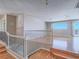 Upstairs landing with hardwood floors, decorative railing, and picturesque window at 420 Dakar St, Henderson, NV 89015