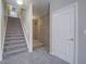 Carpeted stairs with white railing next to unfinished basement section and a white door at 420 Dakar St, Henderson, NV 89015