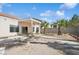 View of the backyard with covered patio and desert landscaping at 4323 Village Spring St, Las Vegas, NV 89147