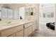 Bright bathroom with double sink vanity, natural wood cabinets, and neutral color scheme at 4323 Village Spring St, Las Vegas, NV 89147