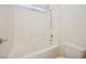 Bright bathroom featuring a tub and shower combination with white tiling and fixtures at 4323 Village Spring St, Las Vegas, NV 89147