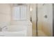 Modern bathroom featuring a soaking tub next to glass door shower at 4323 Village Spring St, Las Vegas, NV 89147