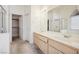 Bathroom with double sink vanity, large mirror, and combination shower/tub at 4323 Village Spring St, Las Vegas, NV 89147