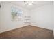 Spacious bedroom with carpet floors, a window with blinds, and built in shelves at 4323 Village Spring St, Las Vegas, NV 89147